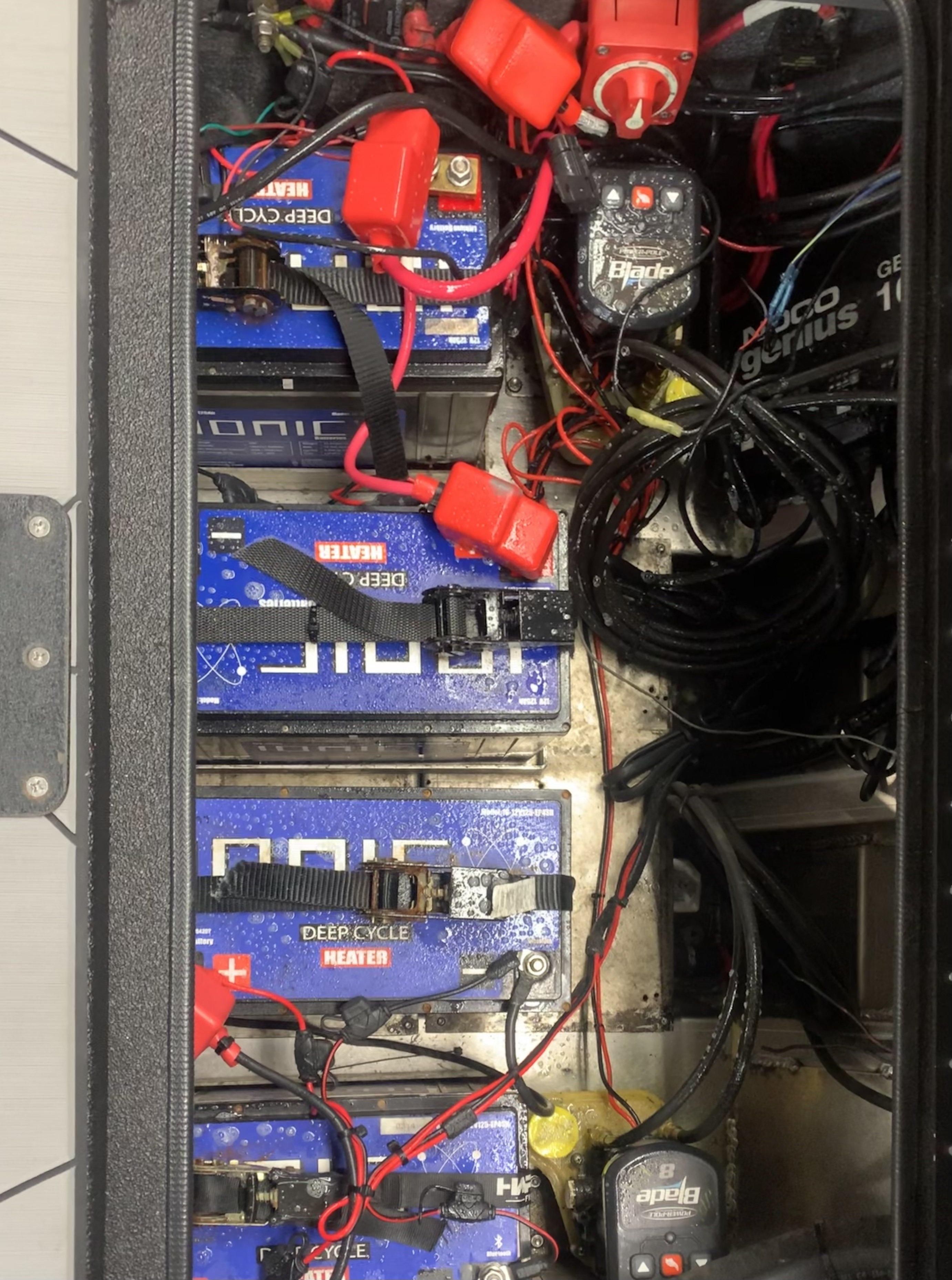 Battery bay before — cluttered wiring